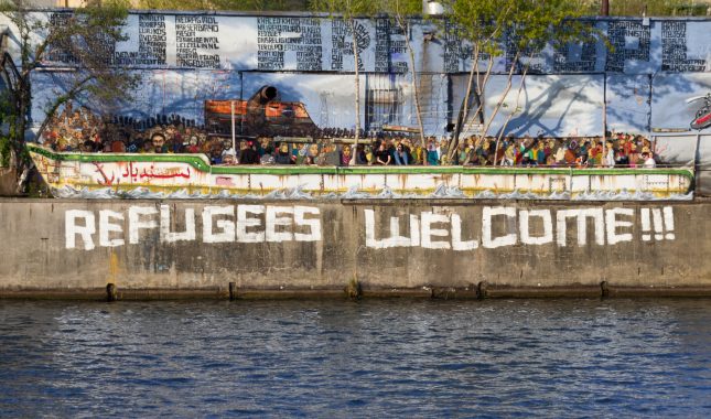 Refugees welcome graffiti and refugee boat in Berlin 